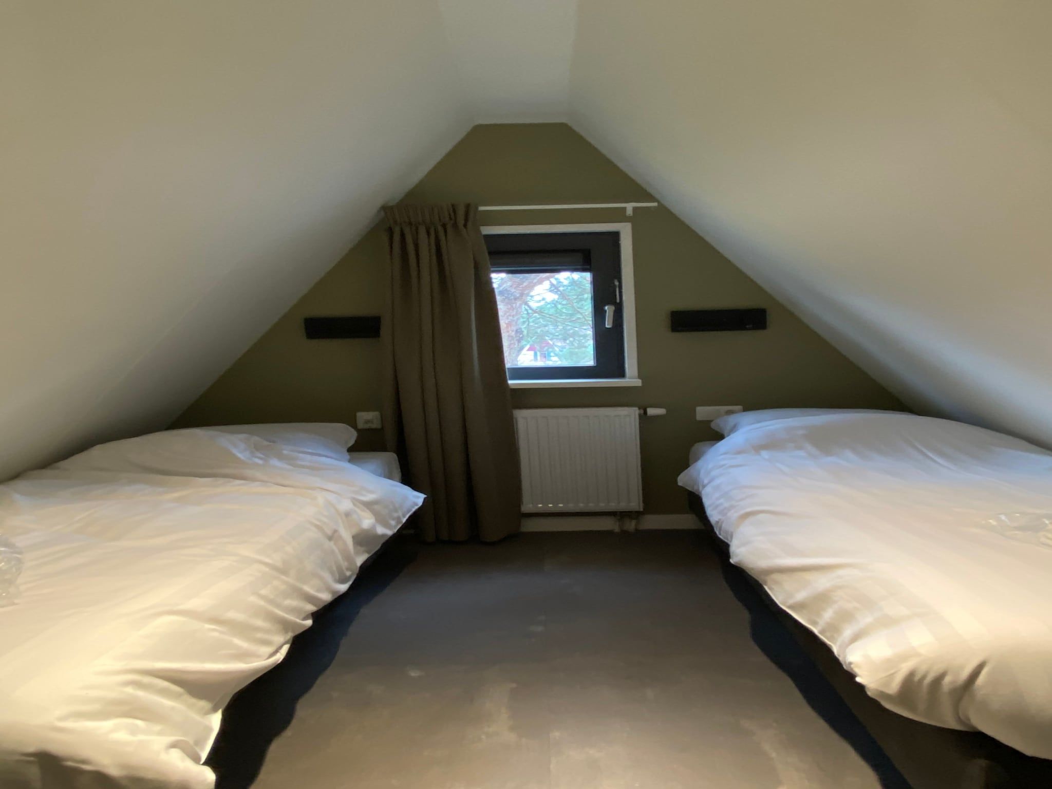 Een slaapkamer van Vakantiepark de Katjeskelder 21 in Oosterhout