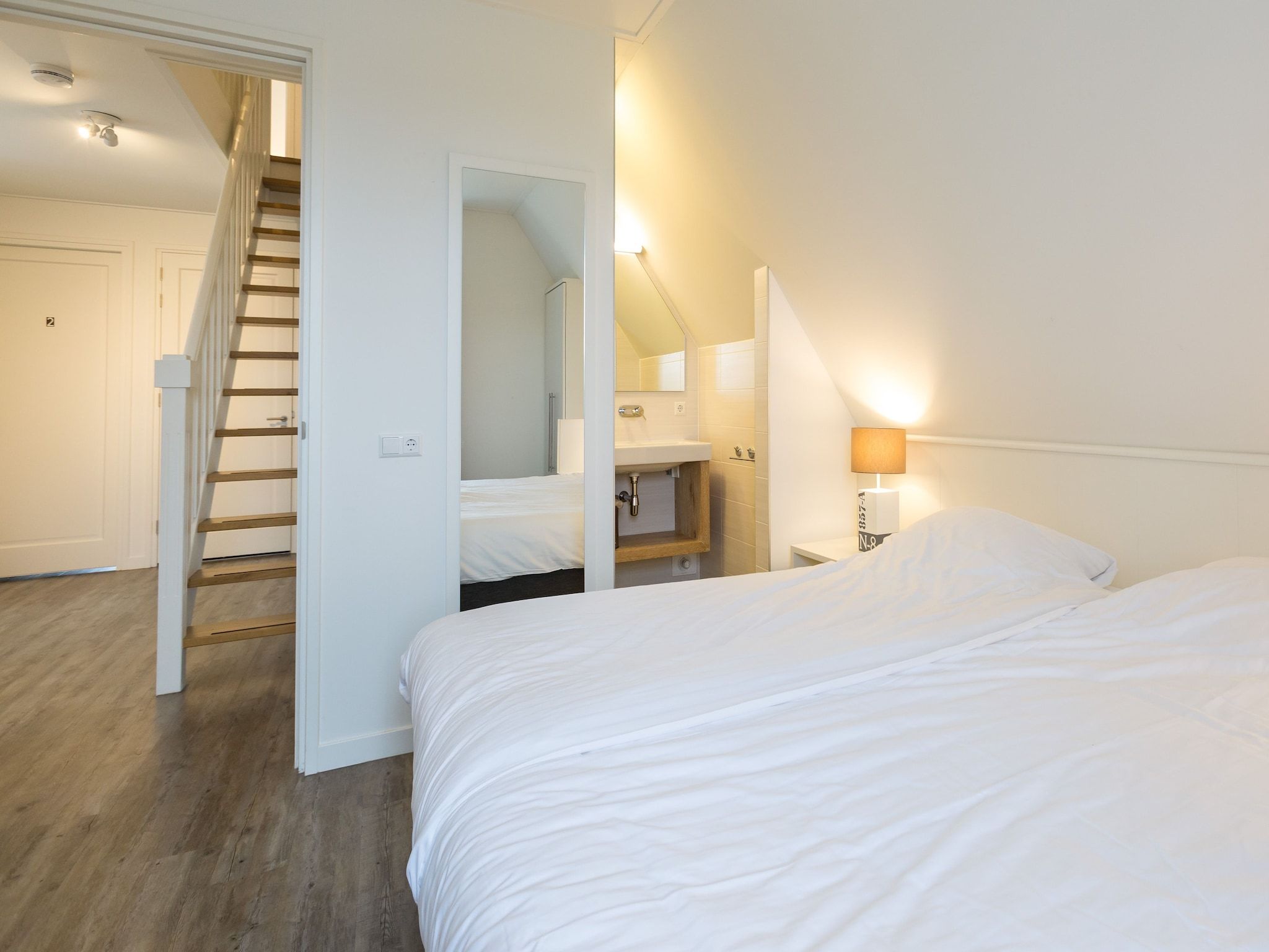 Een slaapkamer van Friese Meren Villa's 17 in Delfstrahuizen