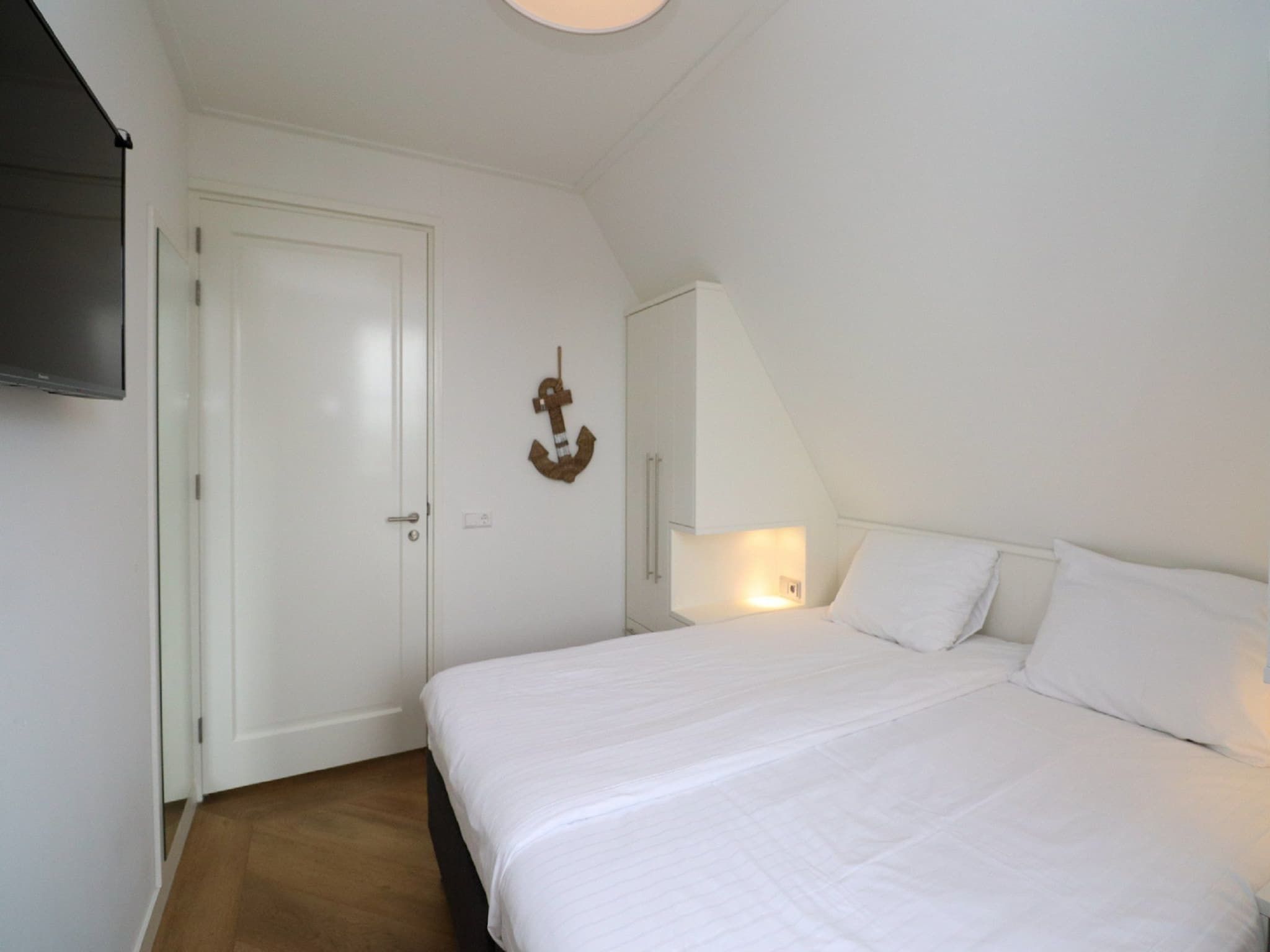 Een slaapkamer van Friese Meren Villa's 16 in Delfstrahuizen