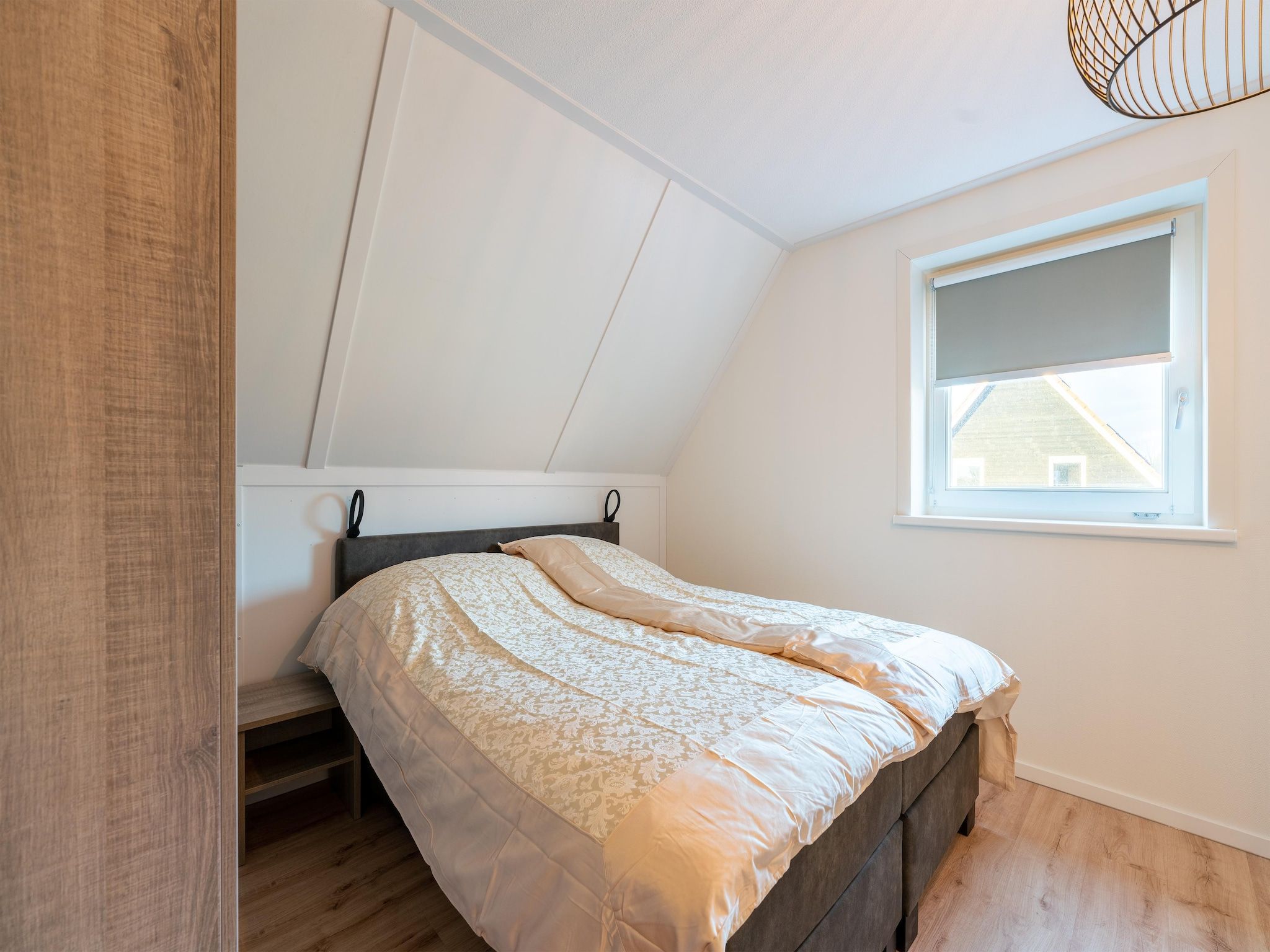 Een slaapkamer van De Ooievaar Huis NR 23 in Scherpenisse