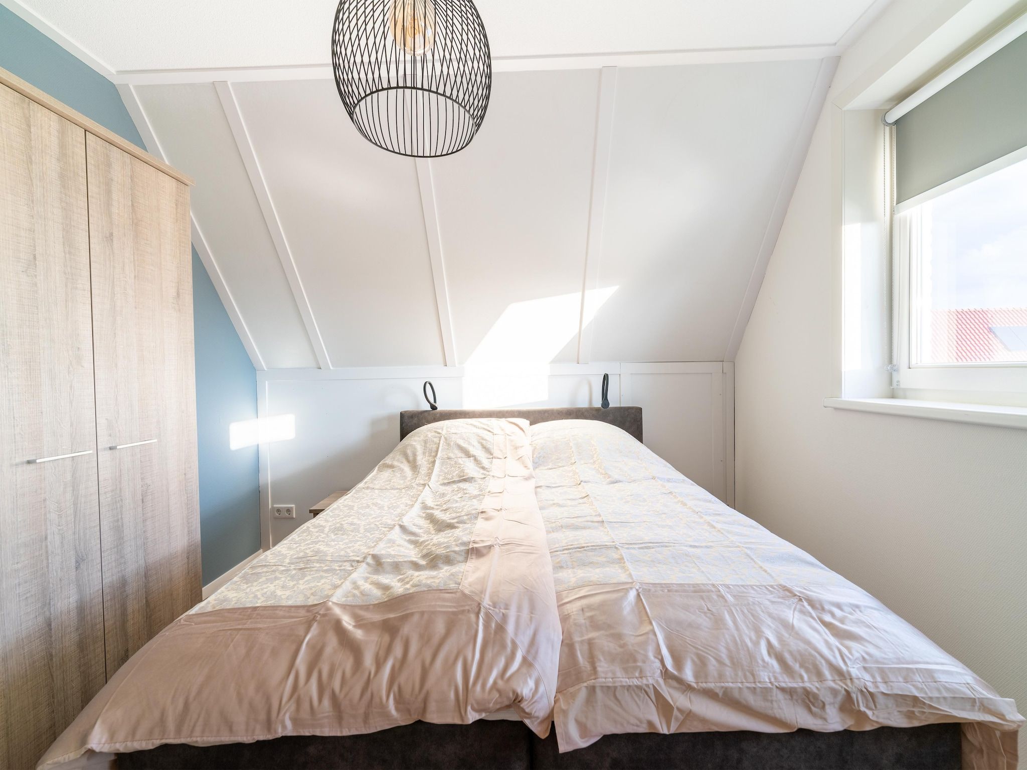 Een slaapkamer van De Ooievaar Huis NR 23 in Scherpenisse