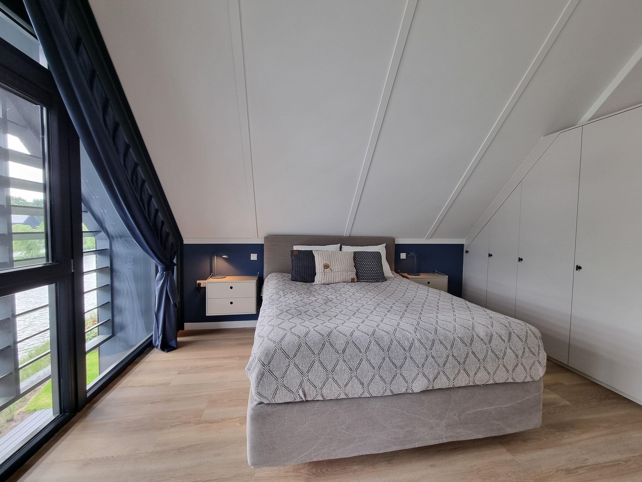 Een slaapkamer van Watervilla Acht in Balk