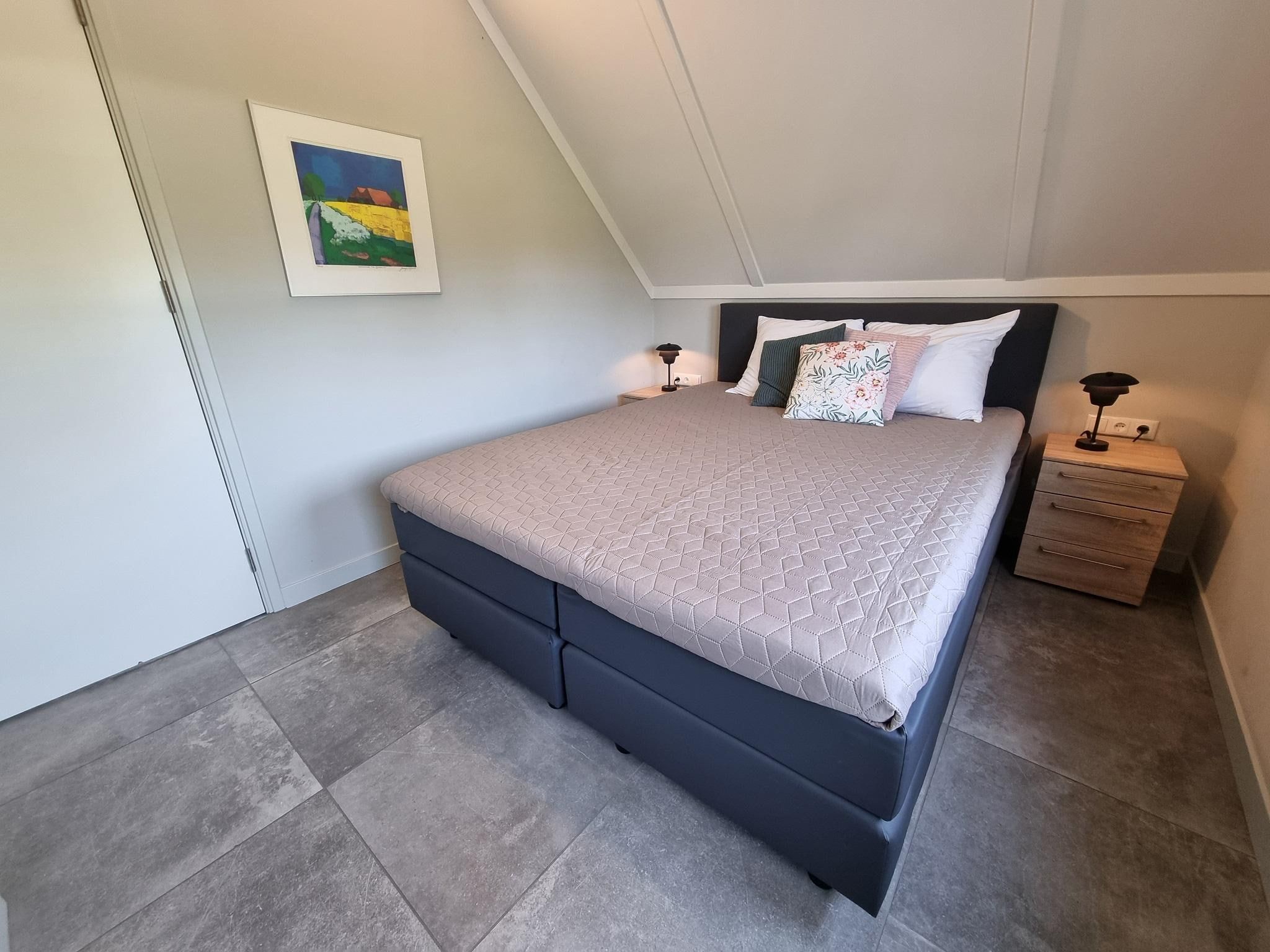 Een slaapkamer van Watervilla Santjin in Balk