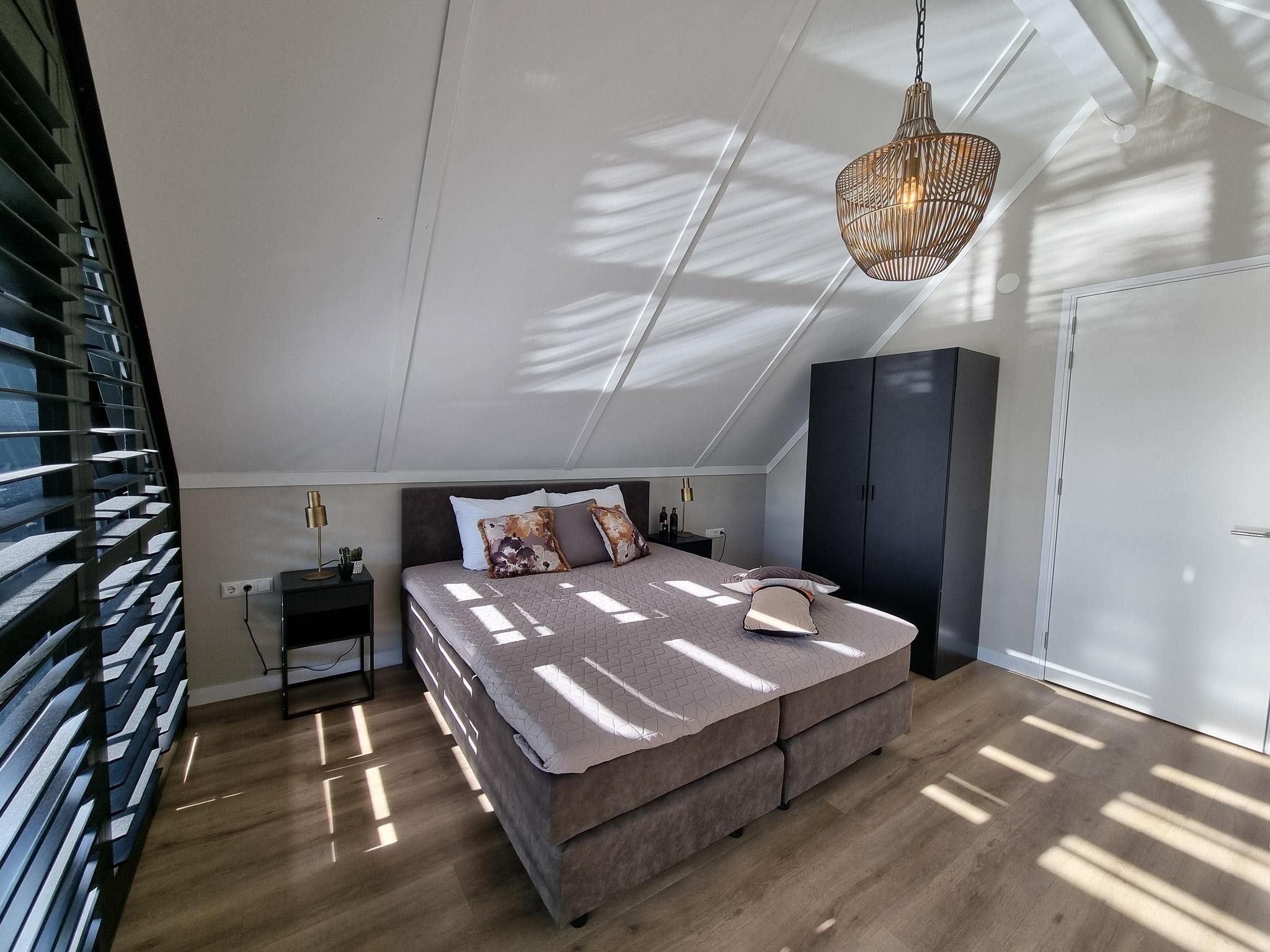 Een slaapkamer van Watervilla Achttjin in Balk