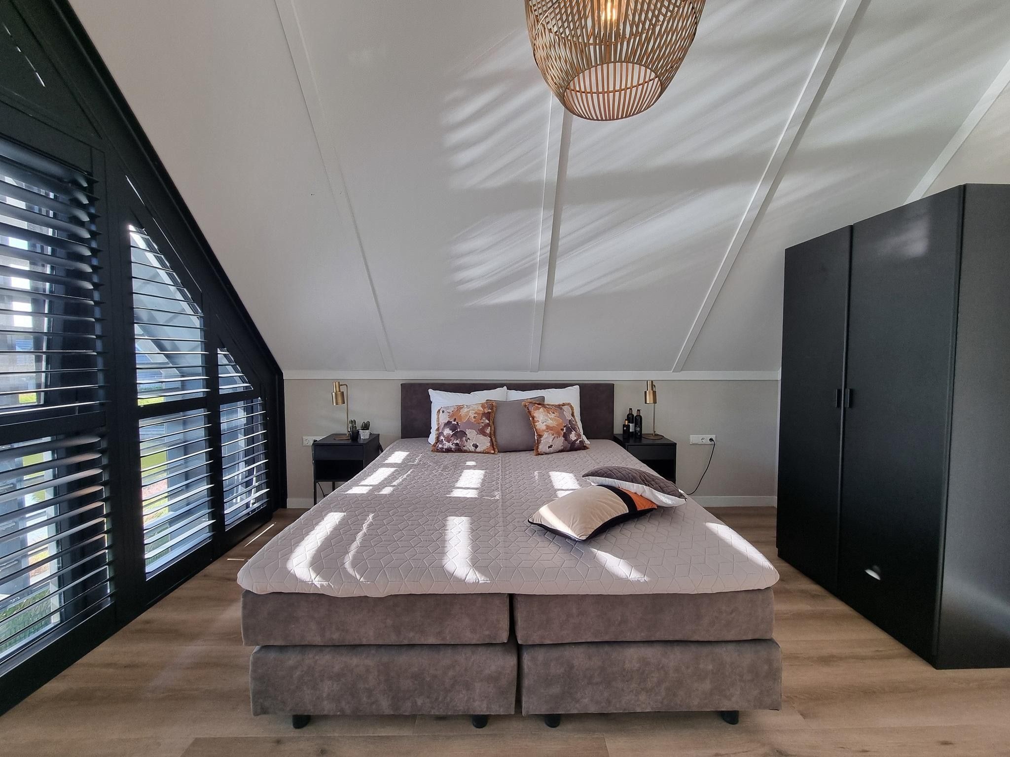 Een slaapkamer van Watervilla Achttjin in Balk