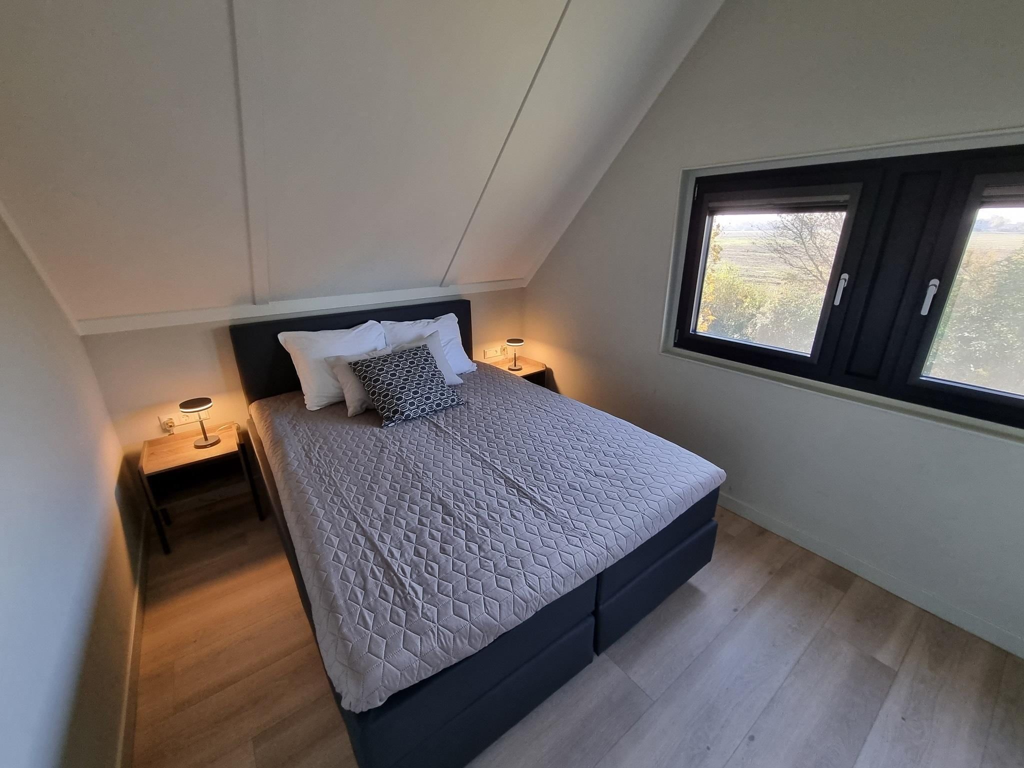 Een slaapkamer van Watervilla Fiif in Balk