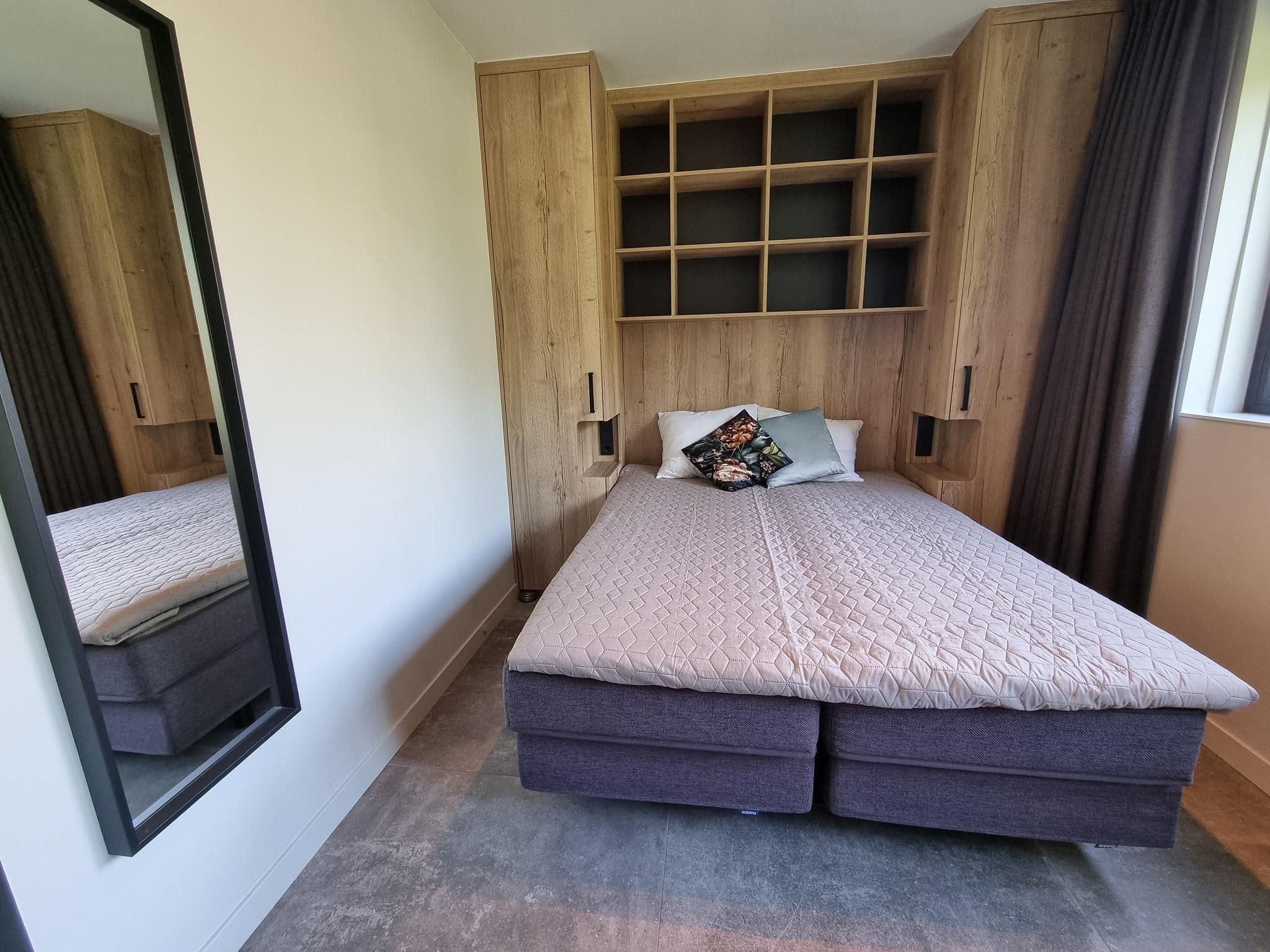 Een slaapkamer van Watervilla Tweintich in Balk