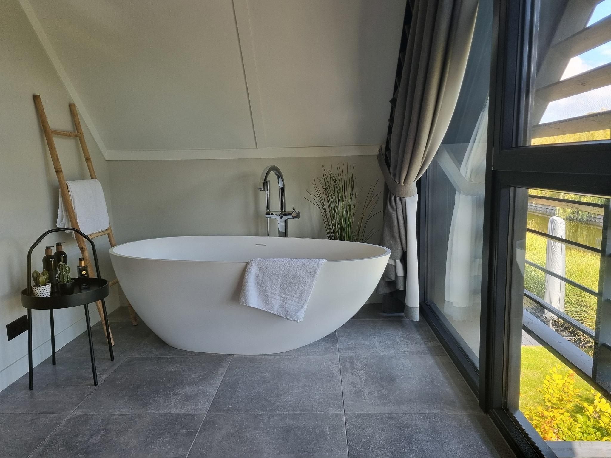 Een slaapkamer van Watervilla Tsien in Balk