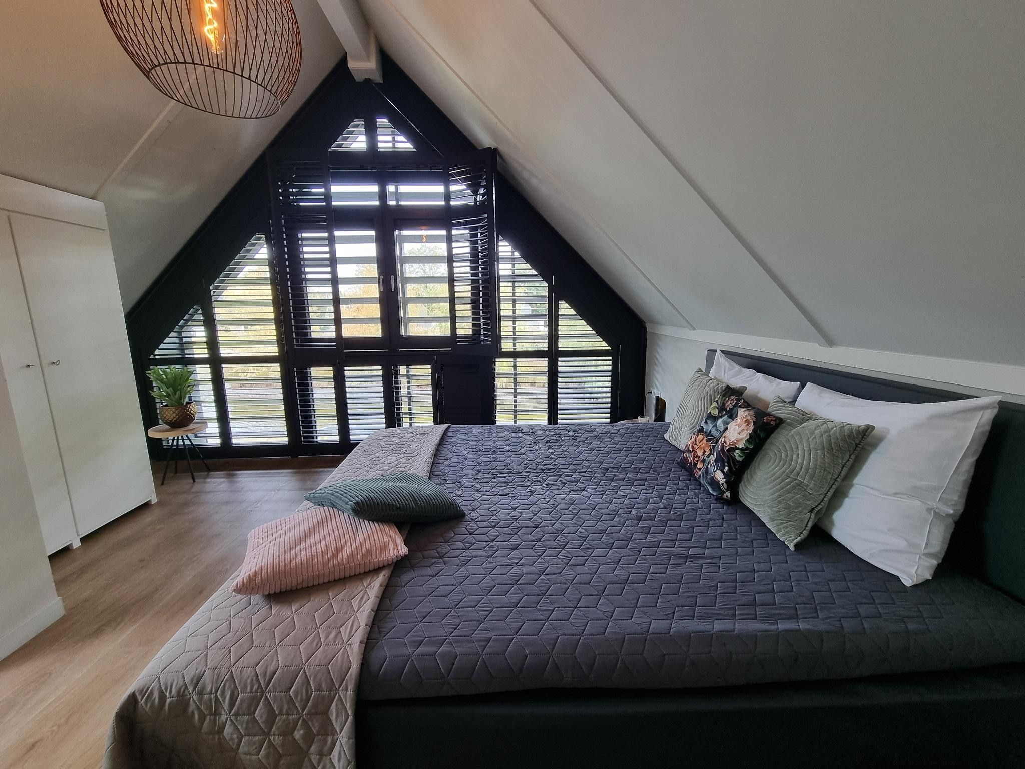 Een slaapkamer van Watervilla Trettjin in Balk