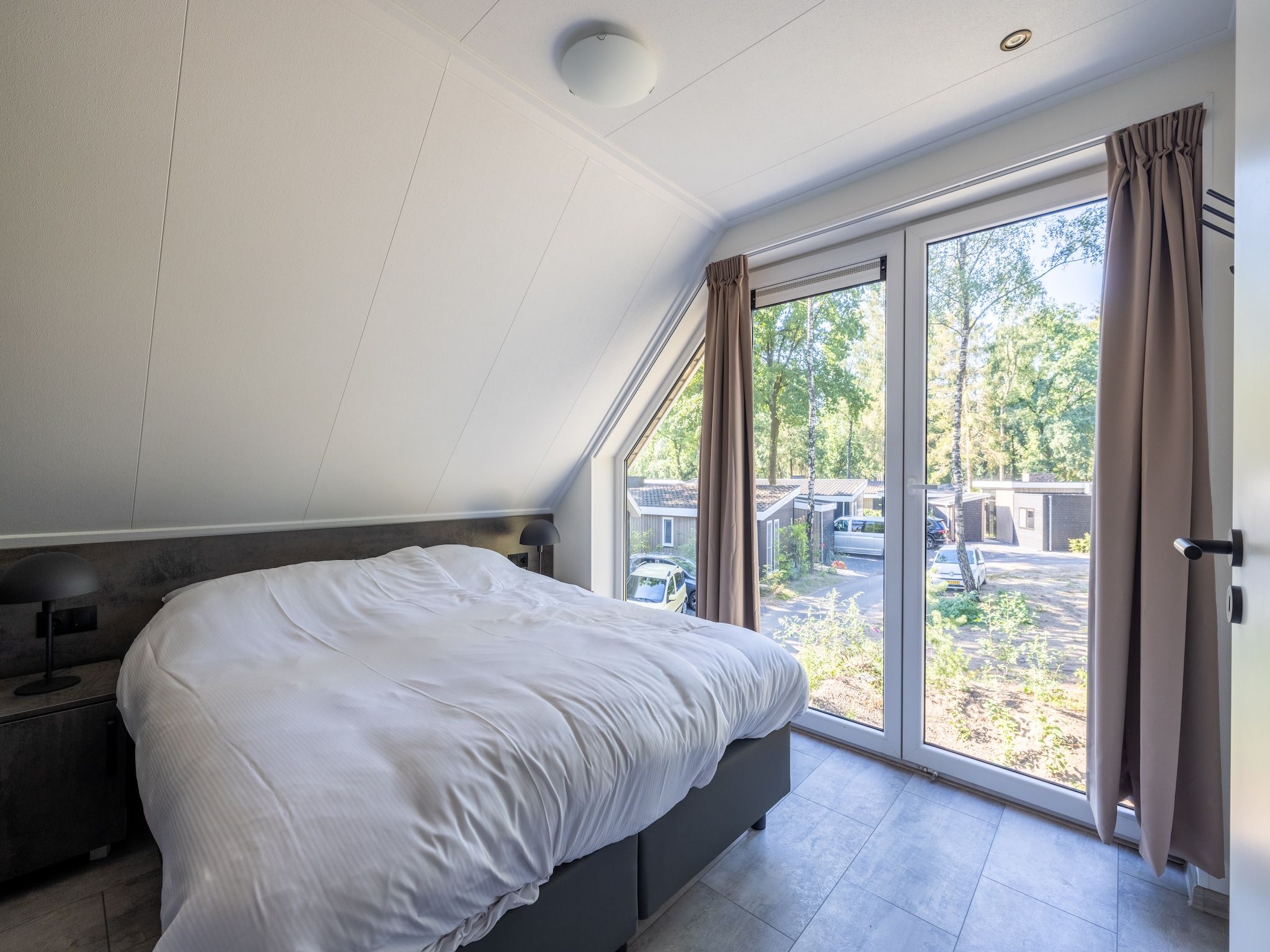 Een slaapkamer van Vakantiepark De Rimboe & De Woeste Hoogte 38 in Hoenderloo