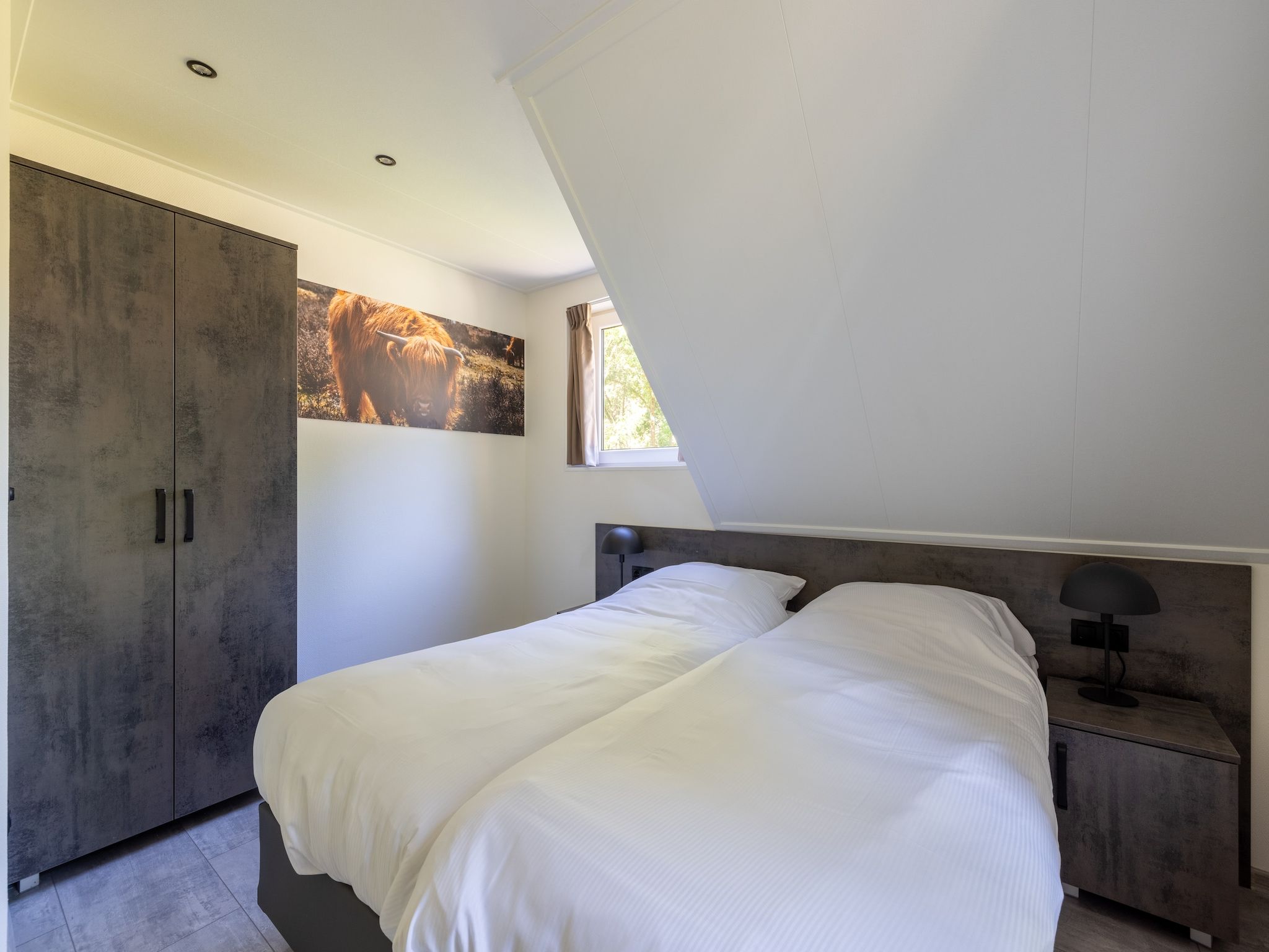 Een slaapkamer van Vakantiepark De Rimboe & De Woeste Hoogte 38 in Hoenderloo