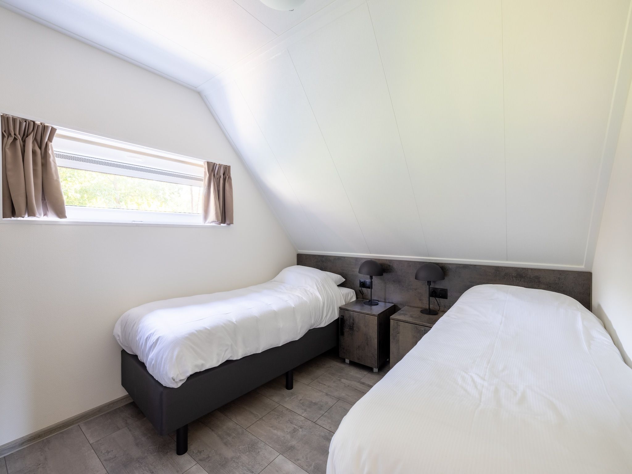 Een slaapkamer van Vakantiepark De Rimboe & De Woeste Hoogte 38 in Hoenderloo