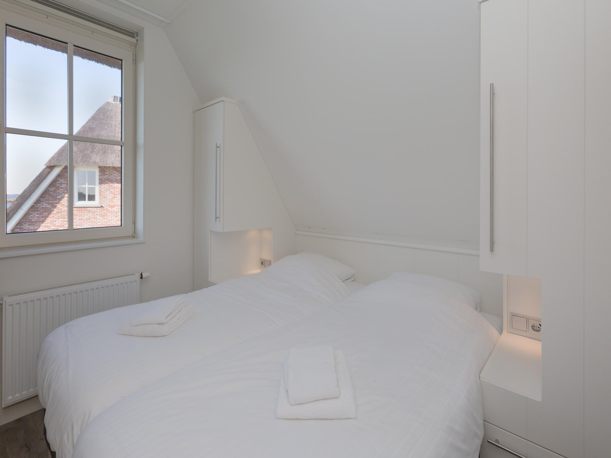 Een slaapkamer van Friese Meren Villa's 18 in Delfstrahuizen