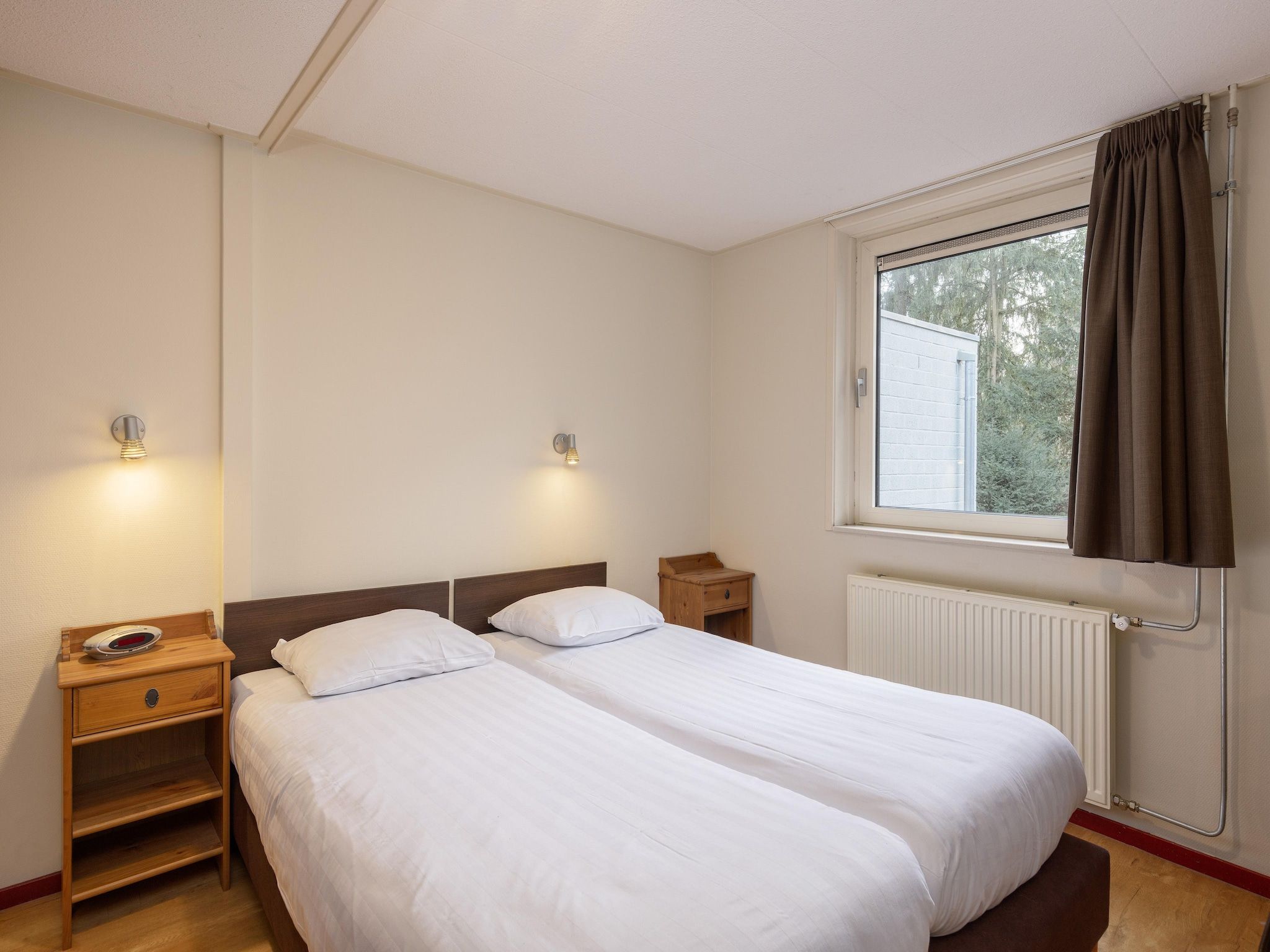 Een slaapkamer van Vakantiepark de Berkenhorst 16 in Kootwijk