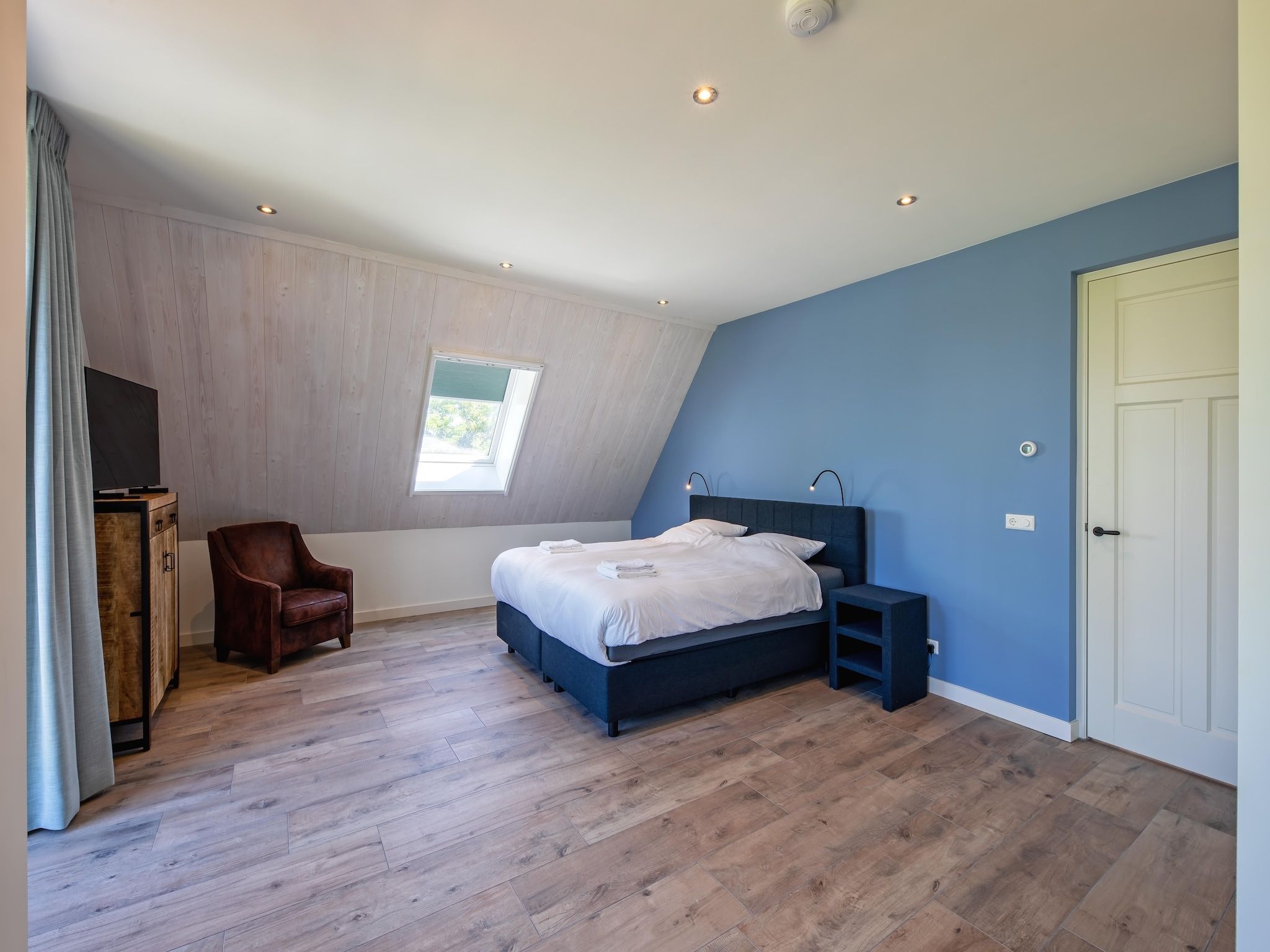 Een slaapkamer van Familievilla Nieuw-Zeeland in Oosterend