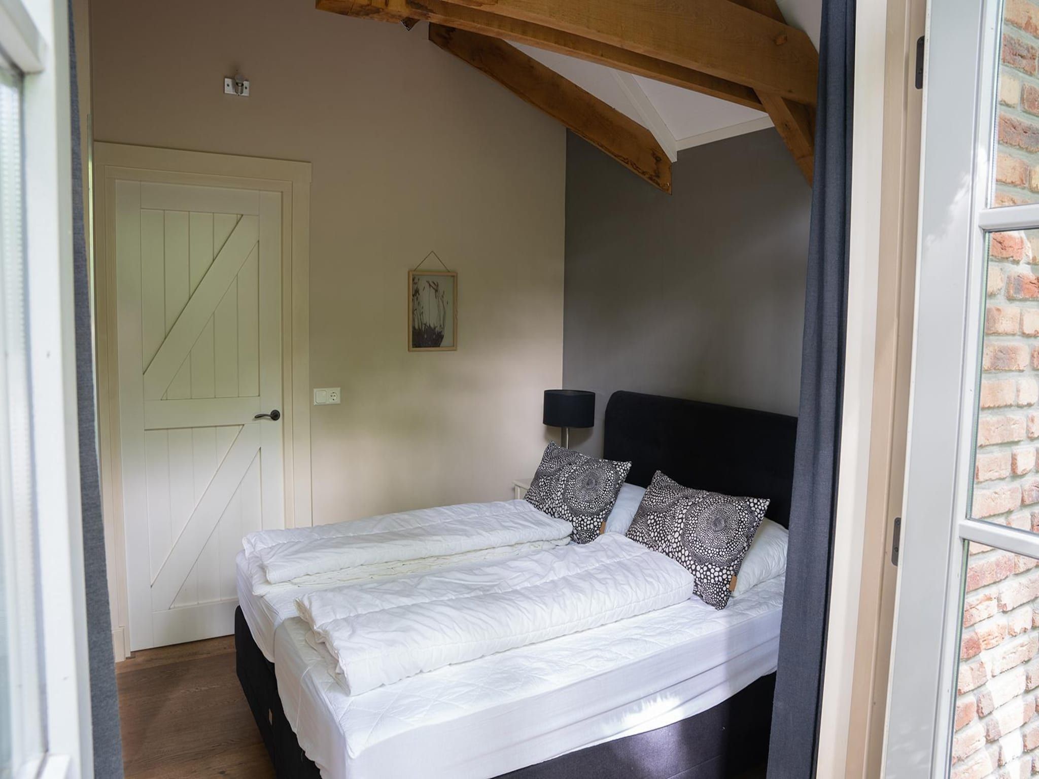 Een slaapkamer van Vlindervallei Villa 8p in Ermelo