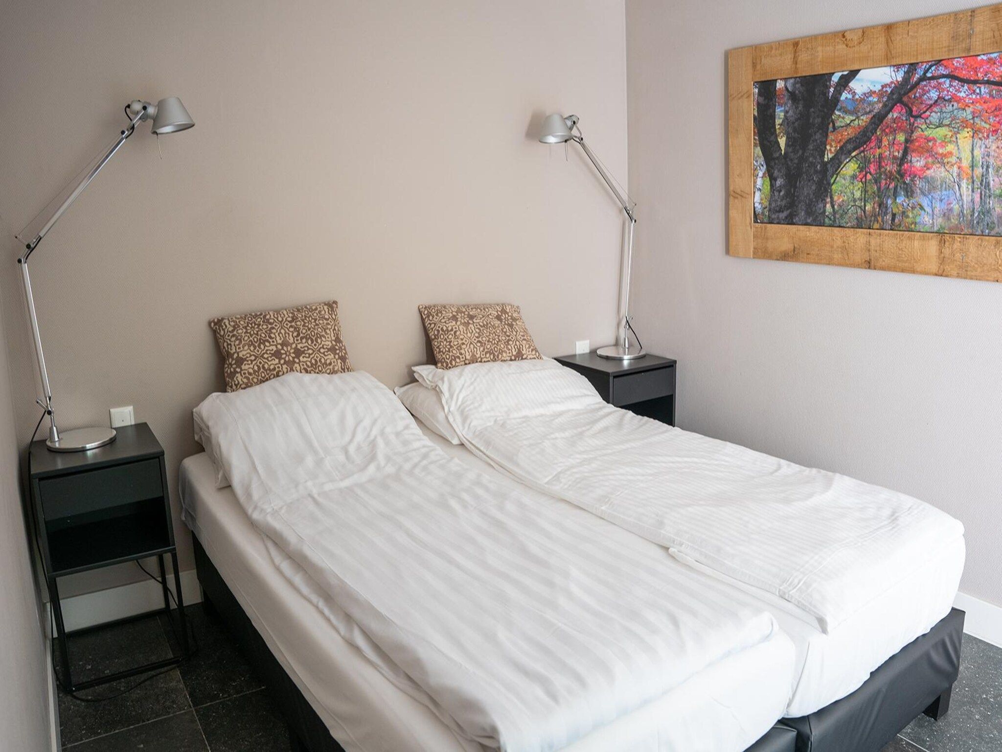 Een slaapkamer van Vlindervallei Boshuis 16p in Ermelo