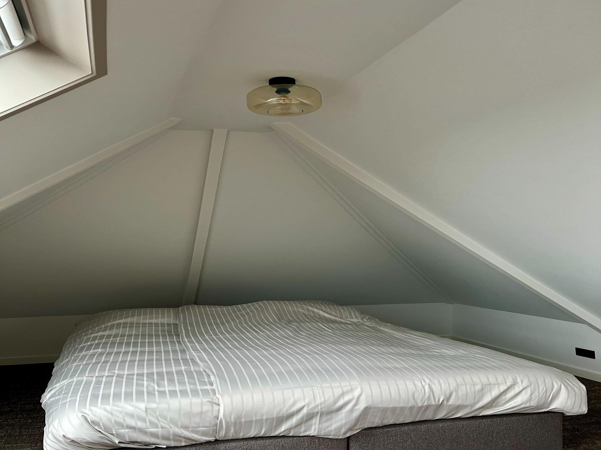 Een slaapkamer van Groepsaccommodatie met 10 luxe tweepersoons kamers in Scherpenzeel (FR)