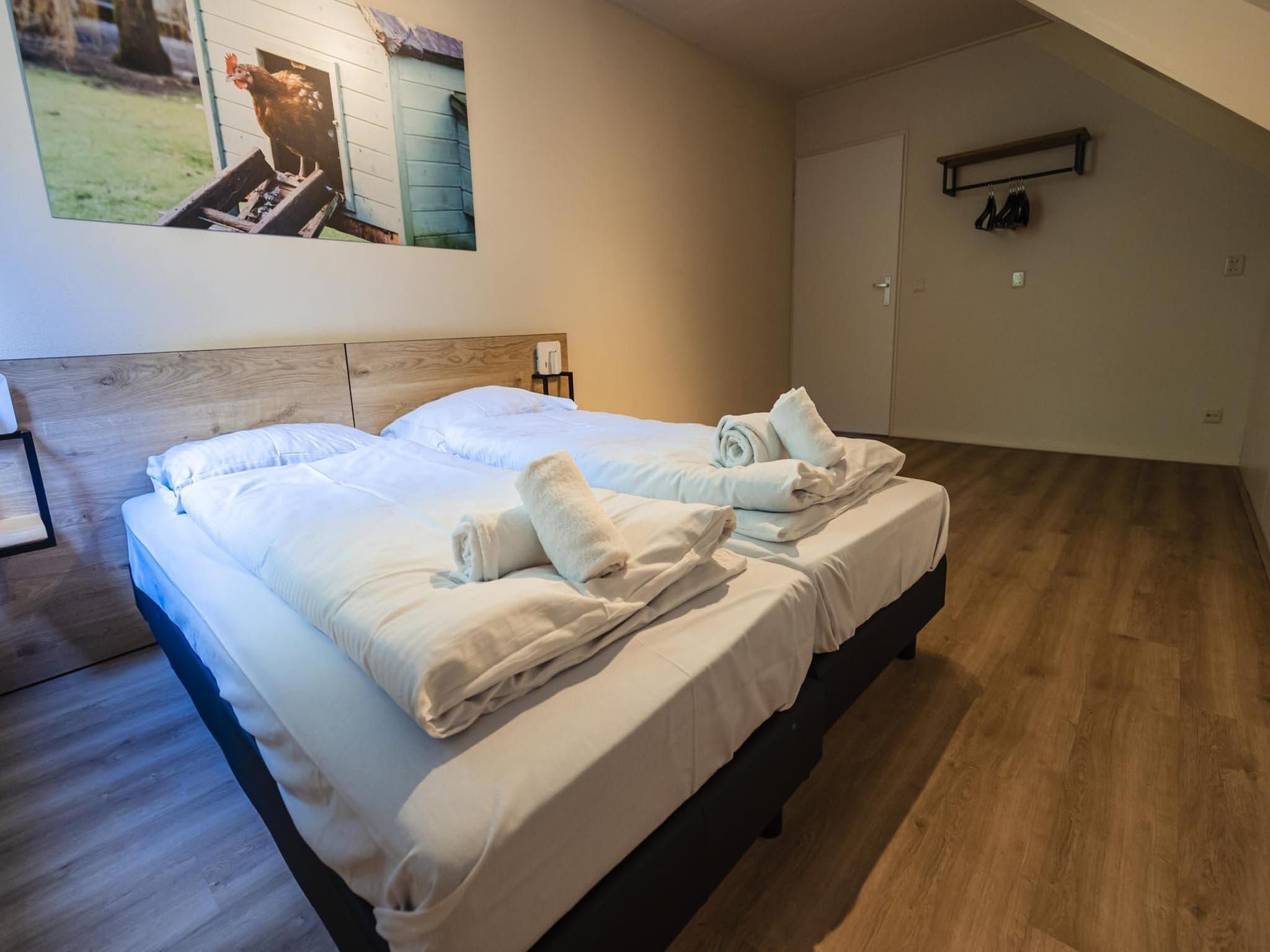 Een slaapkamer van 12 - Persons Family Bungalow in Ewijk