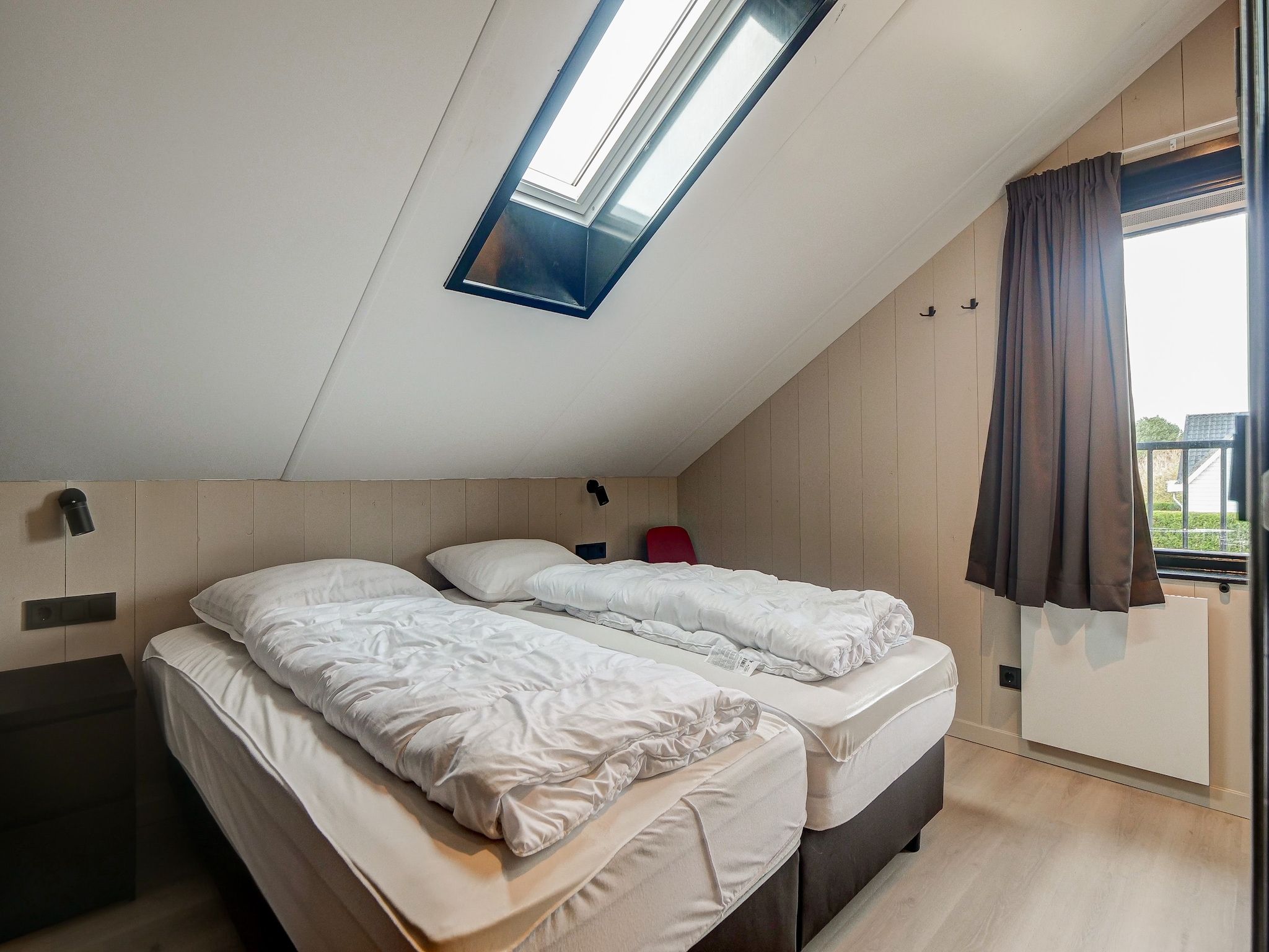 Een slaapkamer van Familiehuis Zee & Zand in Julianadorp