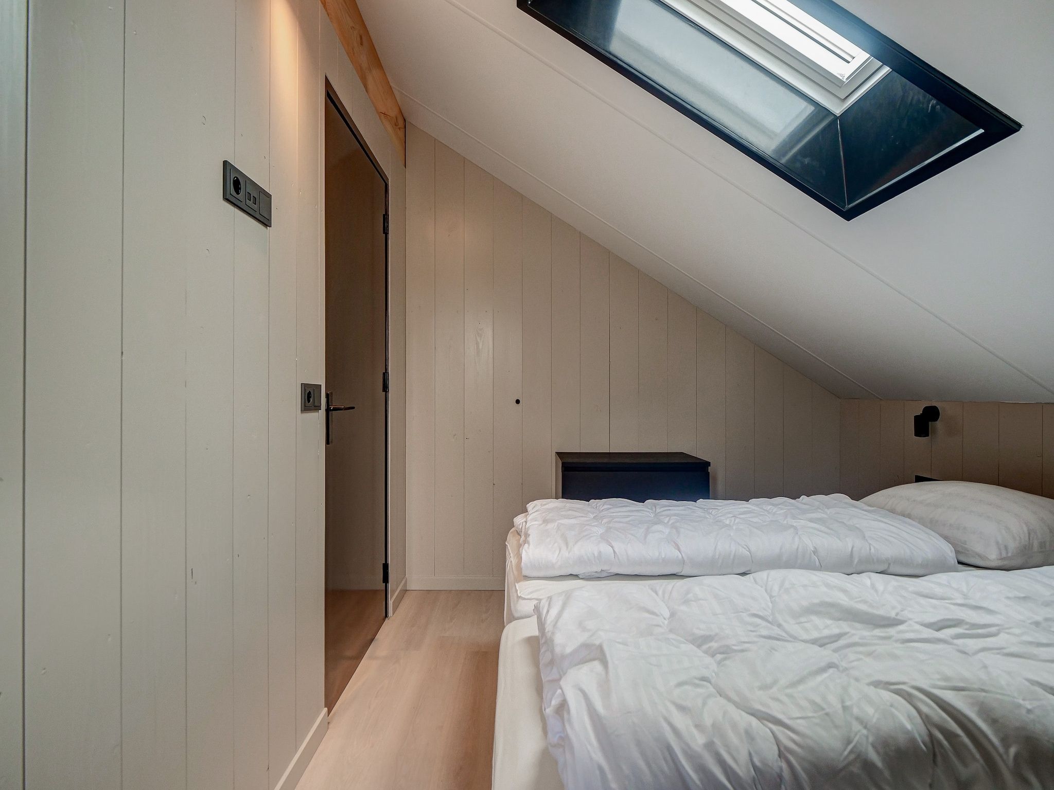 Een slaapkamer van Familiehuis Zee & Zand in Julianadorp