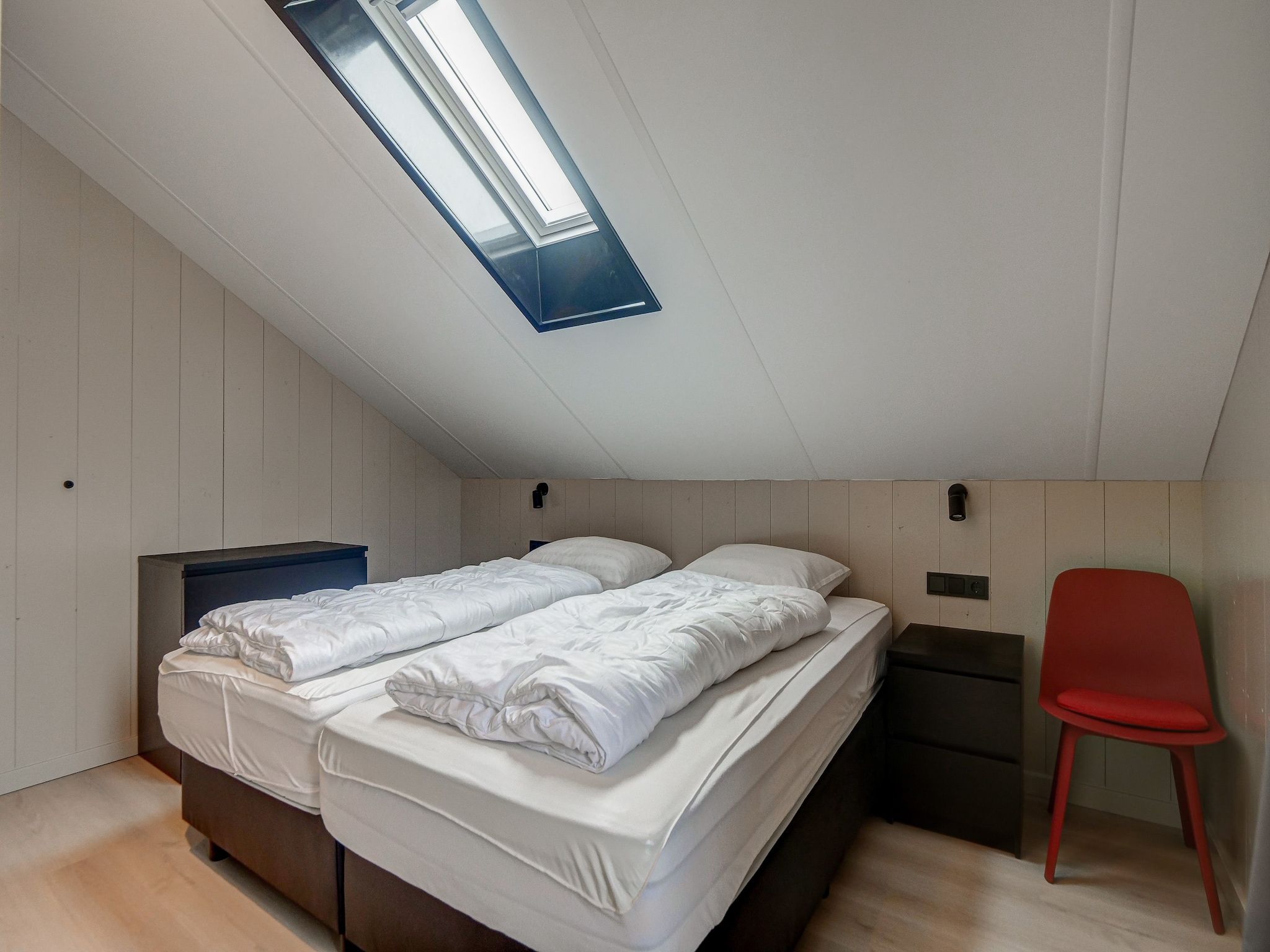 Een slaapkamer van Familiehuis Zee & Zand in Julianadorp