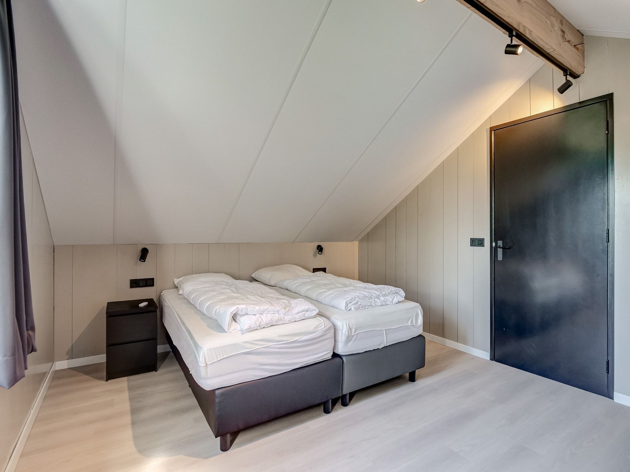 Een slaapkamer van Familiehuis Zee & Zand in Julianadorp