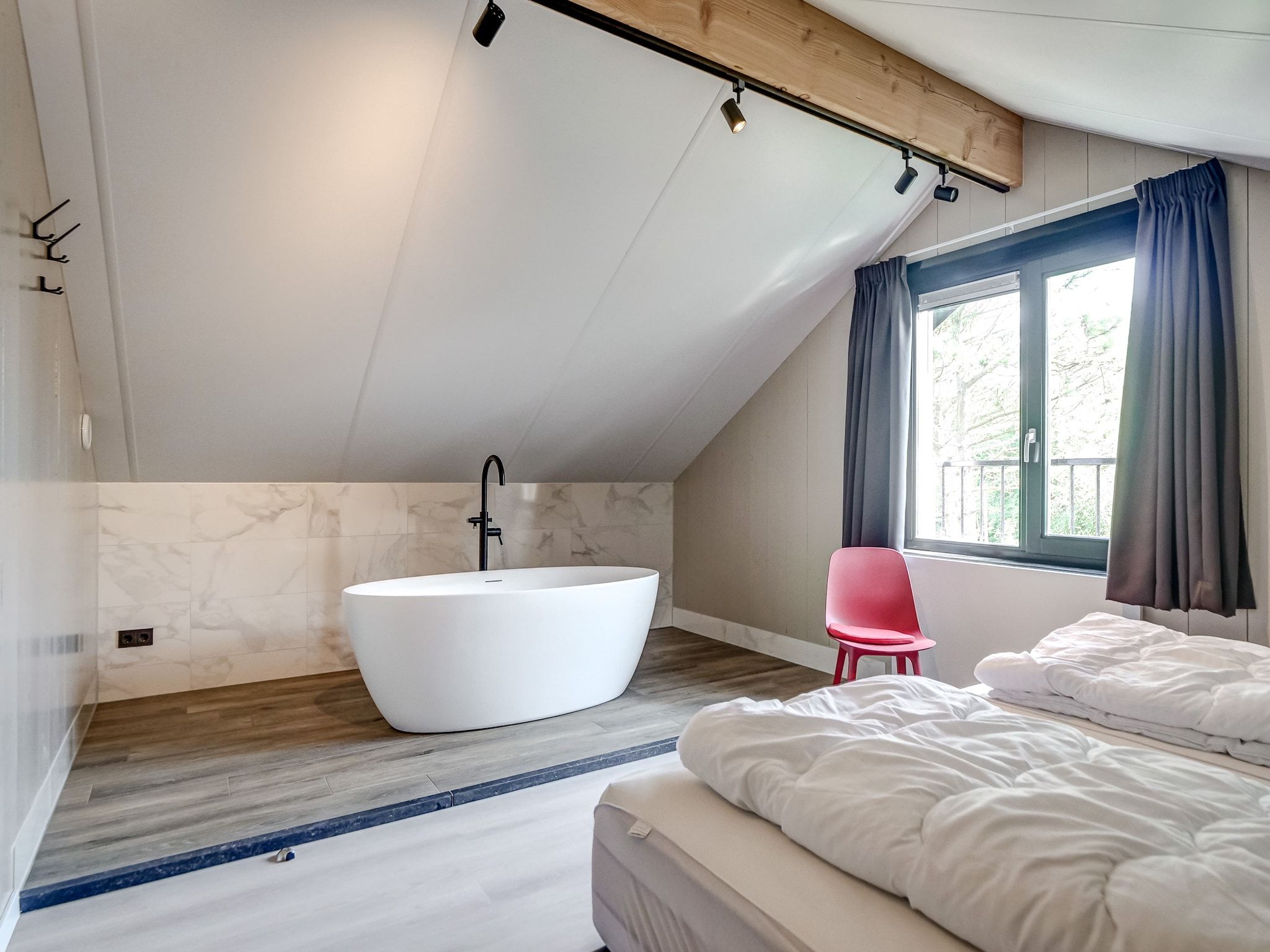 Een slaapkamer van Familiehuis Zee & Zand in Julianadorp