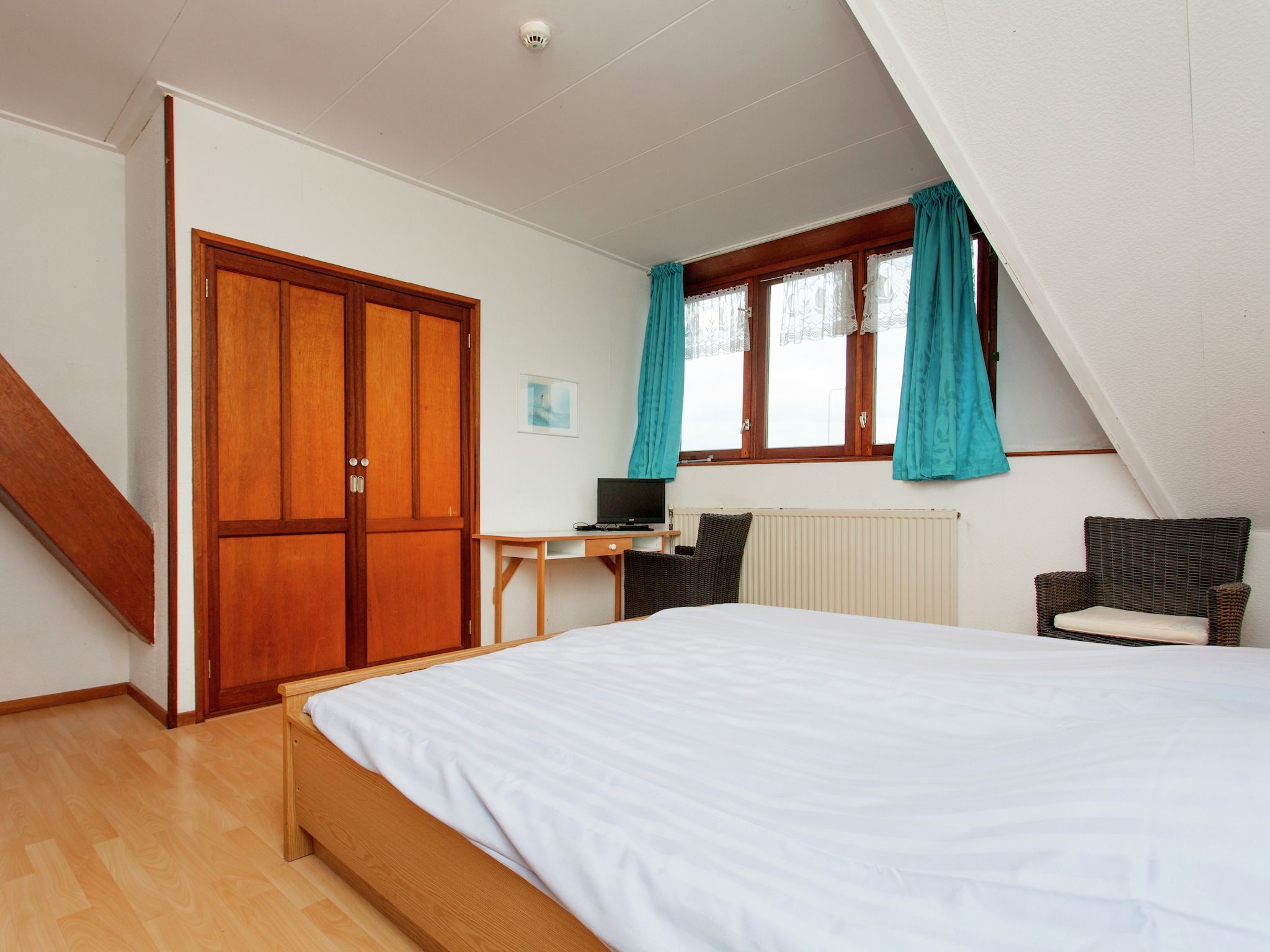 Een slaapkamer van De Vakantie boerderij in Holwerd