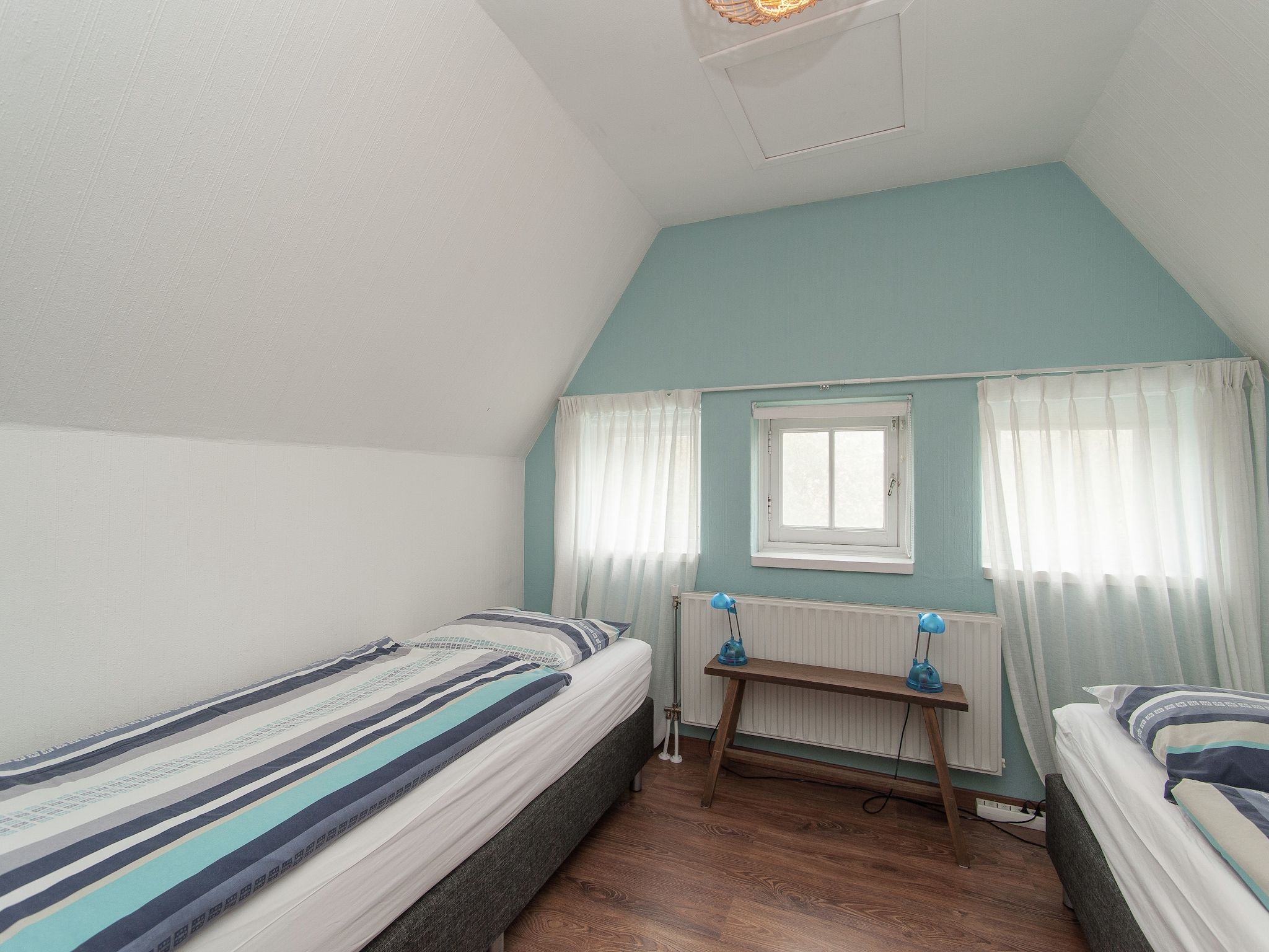 Een slaapkamer van Huize Glory Amethist aan Zee in Bergen aan zee