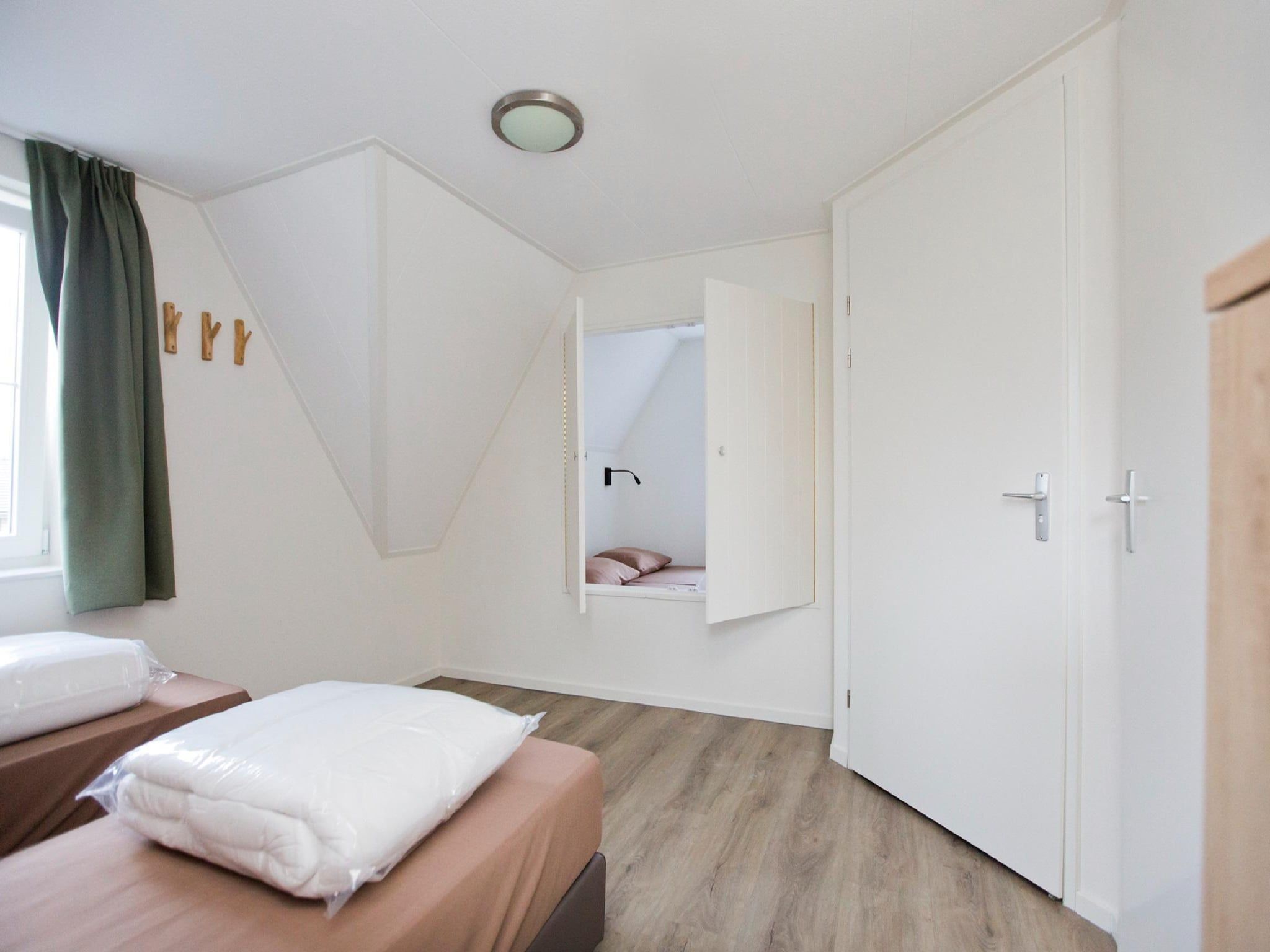 Een slaapkamer van Landgoed De IJsvogel 9 in Voorthuizen