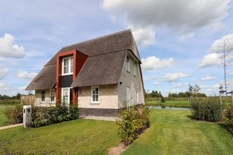 Ontspannende villa met open haard in Delfstrahuizen