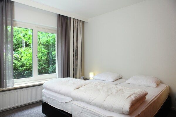 Slaapkamer - Villa van de Veluwe Edge Groep met vuurplaats in Doornspijk (5)