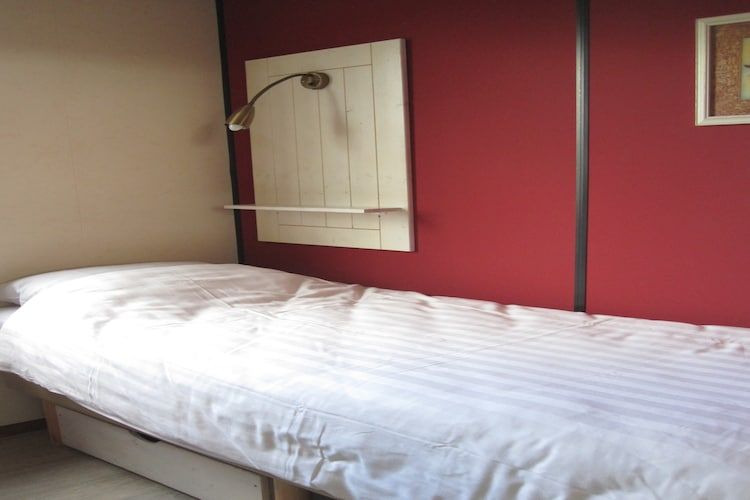 Een slaapkamer van Strandpark Vlugtenburg 6 in 's-Gravenzande